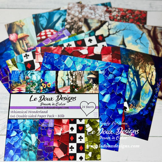 Collection of Le Doux Designs paper packs with colorful designs on a white surface.
